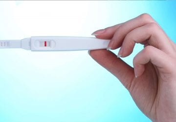 woman holding a home pregnancy test
