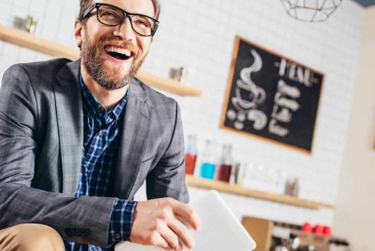 healthy looking man laughing in an office