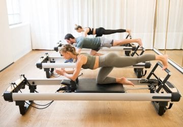 people using a reformer in their pilates class