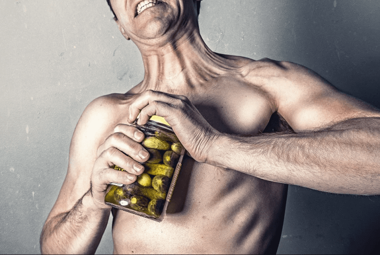 man trying to open a jar of pickles
