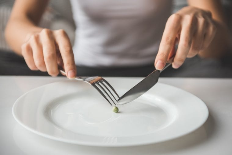 girl eatting a pea