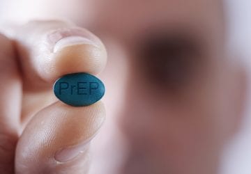 young man with PrEP pill