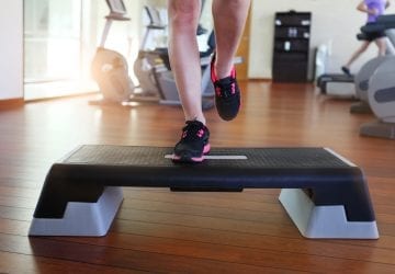 a person exercising on a step at the gym