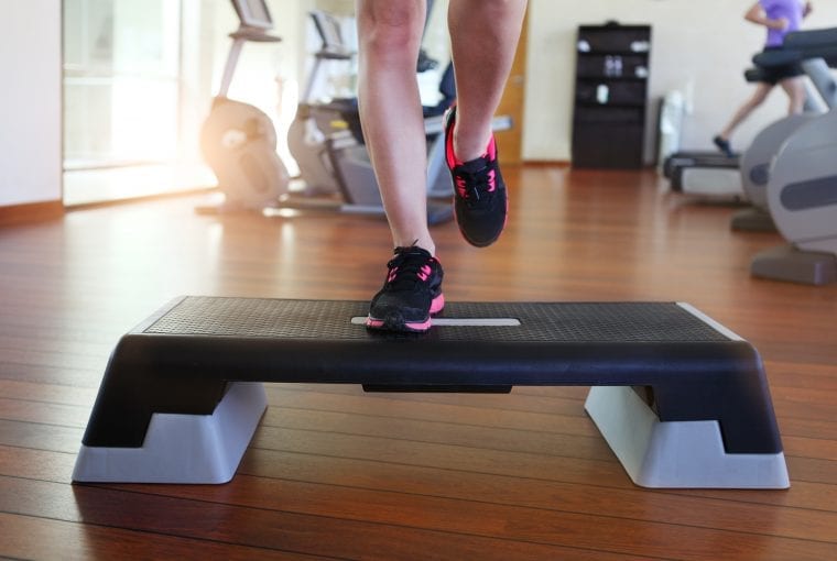 a person exercising on a step at the gym