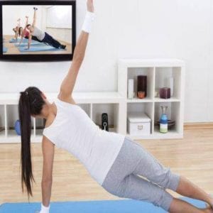 waman exercising in front of a TV