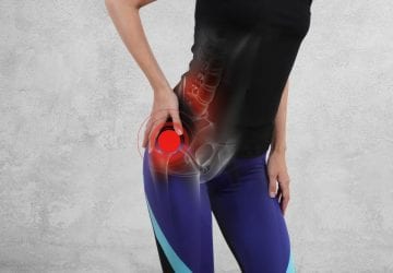 woman holding her hip in pain