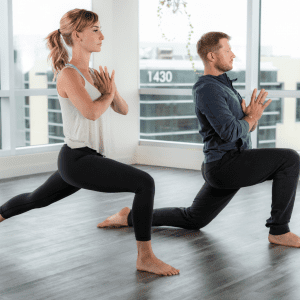 couple doing a yoga pose in the studio