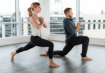 couple doing a yoga pose in the studio