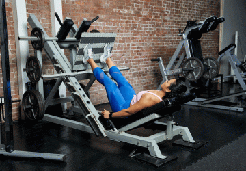 woman doing leg presses in the gym