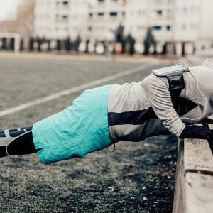 athlete doing push-ups on an outdoor bench