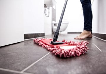 woman cleaning the floor with a mop