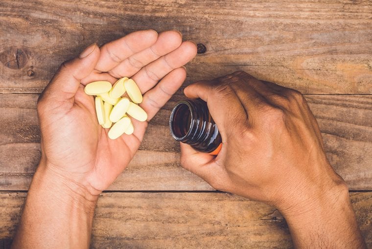 supplements being poured onto hand