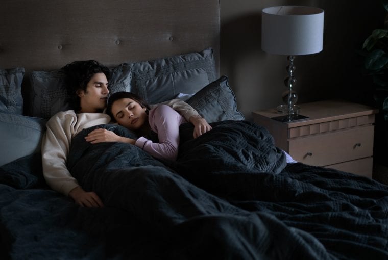 people sleeping under a weighted blanket