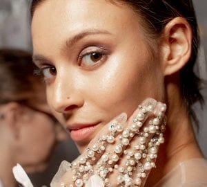 woman with beautiful skin touching her face