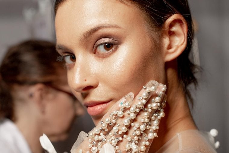 woman with beautiful skin touching her face