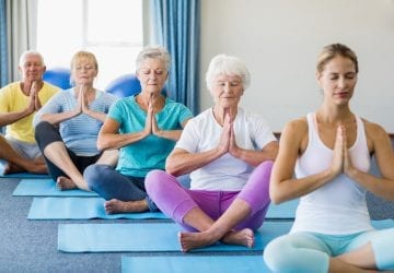 a group of seniors doing yoga