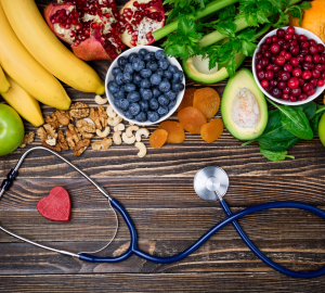 a grouping of healthy foods beside a stethoscope