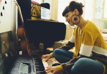 a woman playin gkeyboard in her living room
