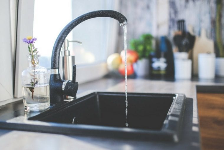 water drippig from a faucet into the sink