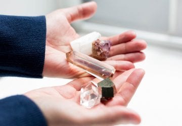 a woman holding a group of crystals