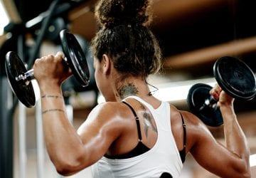 a woman doing a shoulder workout at the gym