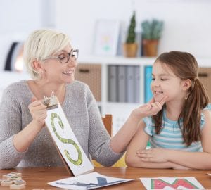 a girl working with a speech pathologist