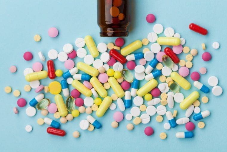 an assortment of pills on a table
