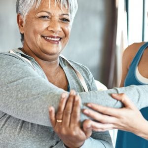 a older woman working out with a trainer