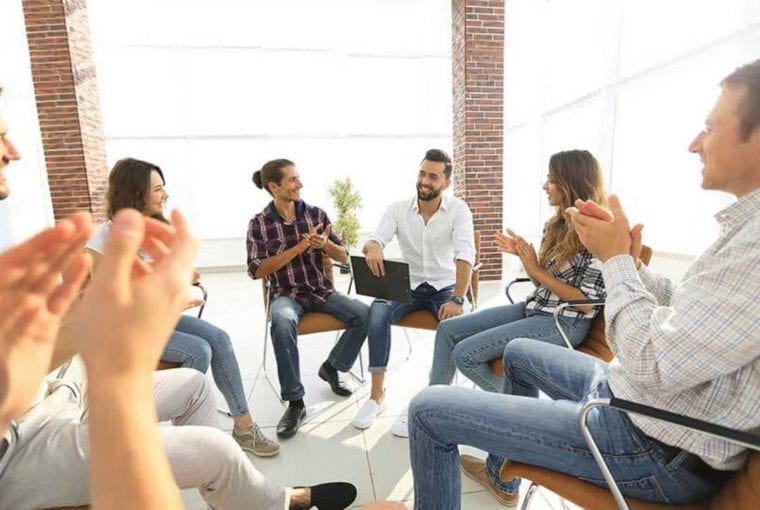 a group cheering in a counselling session