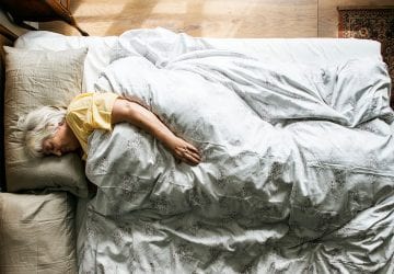 an older woman in her bed sleeping