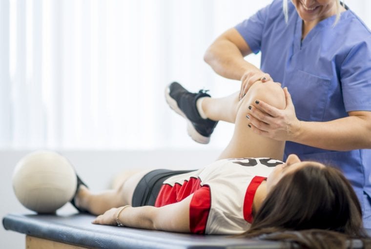 a doctor doing a treatment on an athlete