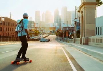 a man commuting to work on a skateboard