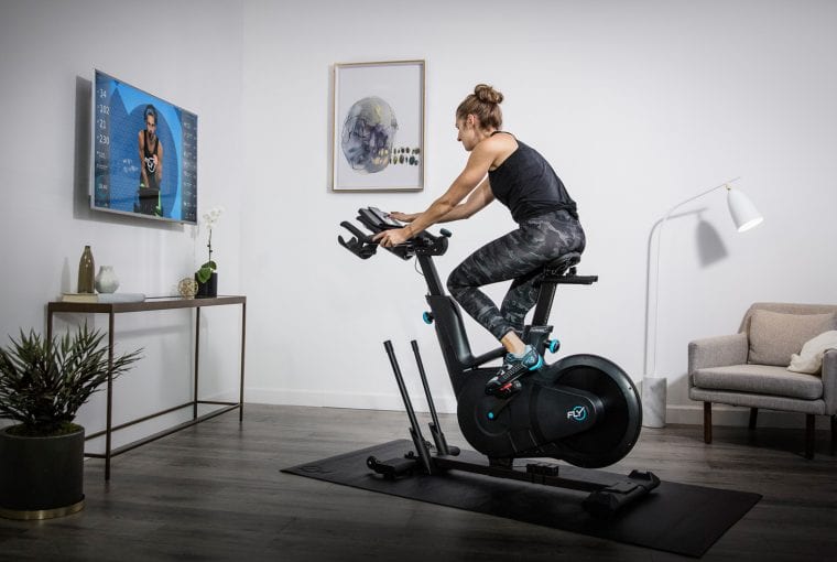 a woman spinning on an exercise bike