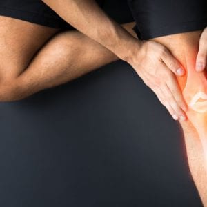 a person holding their knee