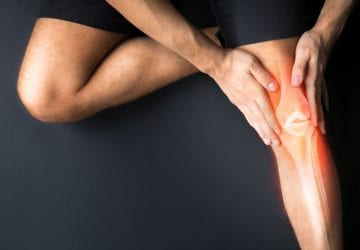 a person holding their knee