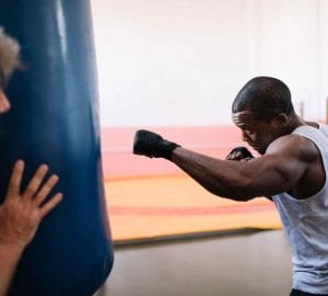 a man boxing with a heavy bag
