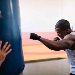 a man boxing with a heavy bag