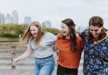 a group of friends walking and laughing outdoors