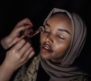 a woman applying makeup
