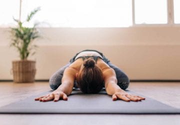 a woman lying face down doing yoga