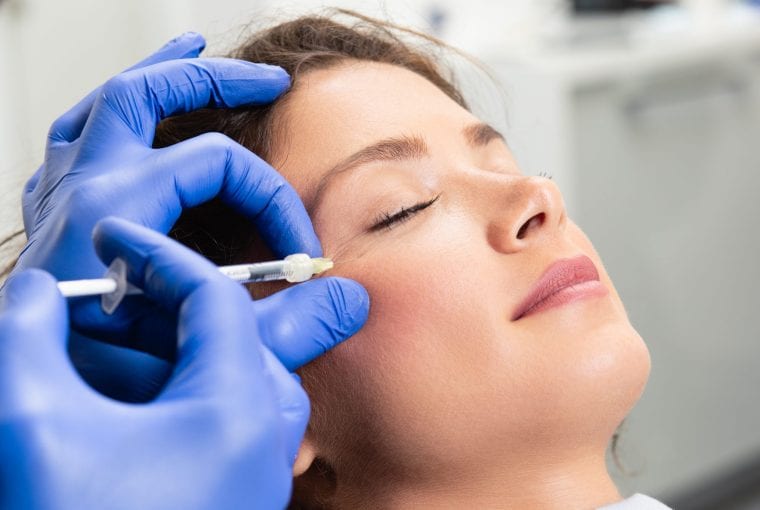 a woman receiving botox in her face