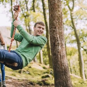 a couple swinging on a tree