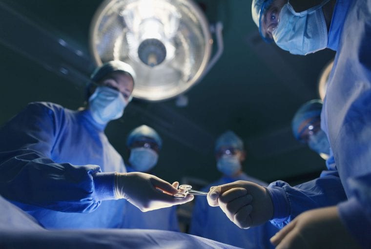a group of surgeons in an operating room