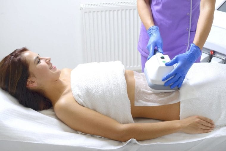 a woman receiving a fat freezing treatment