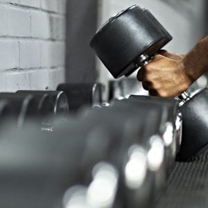 a man picking up a dumbell