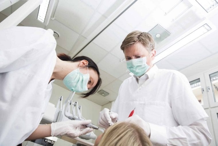 dentists working with a patient