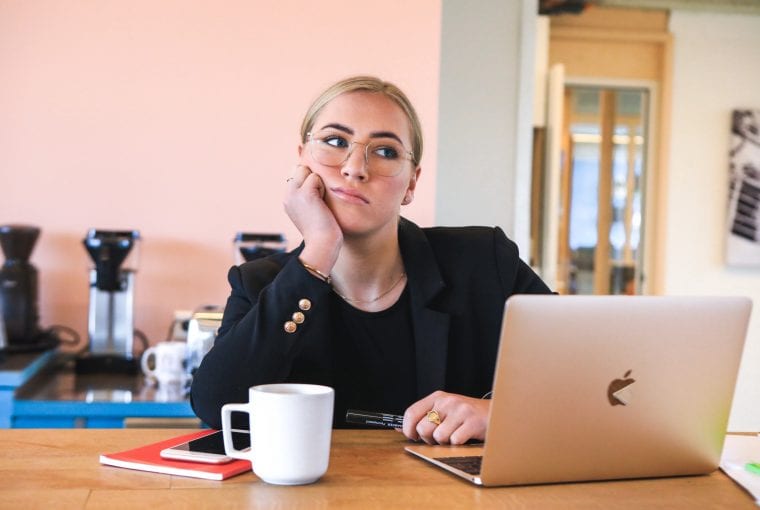 a woman looking at her laptop