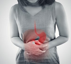 a woman holding her stomach in pain