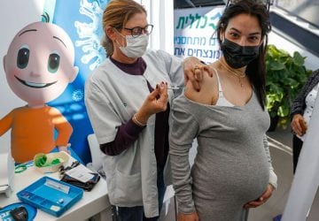 a pregnant woman getting a vaccine