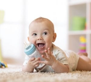 a baby boy drinking a bottle